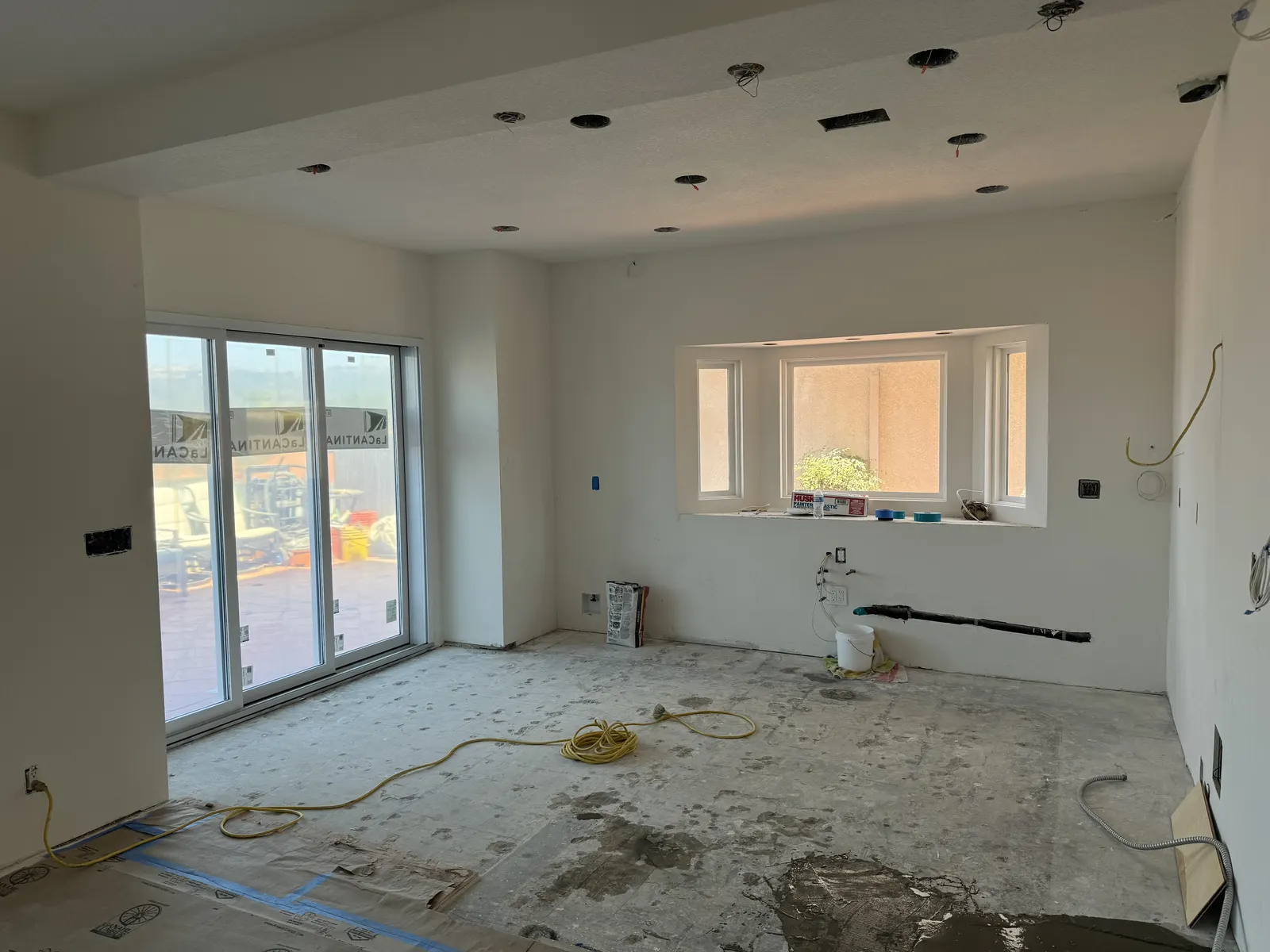 After: the same room with new sliding glass doors installed in the openings