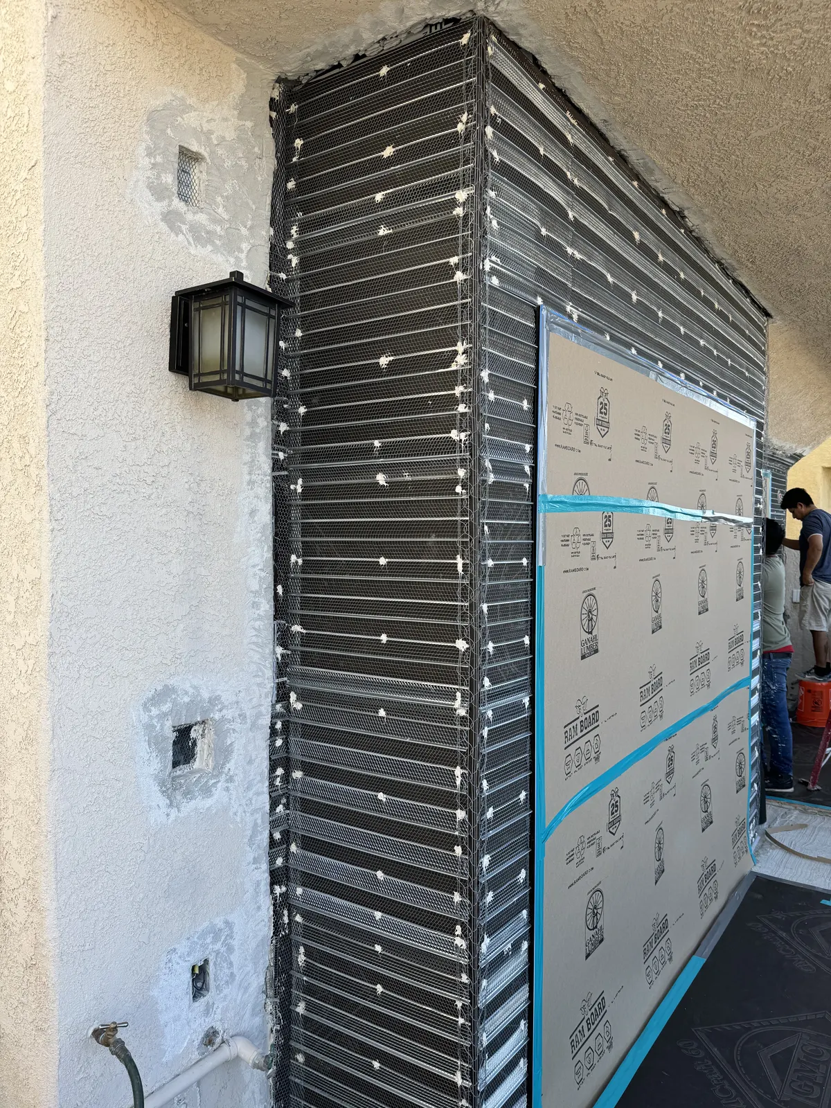 Exterior wall covered in building paper and metal lath, ready for stucco