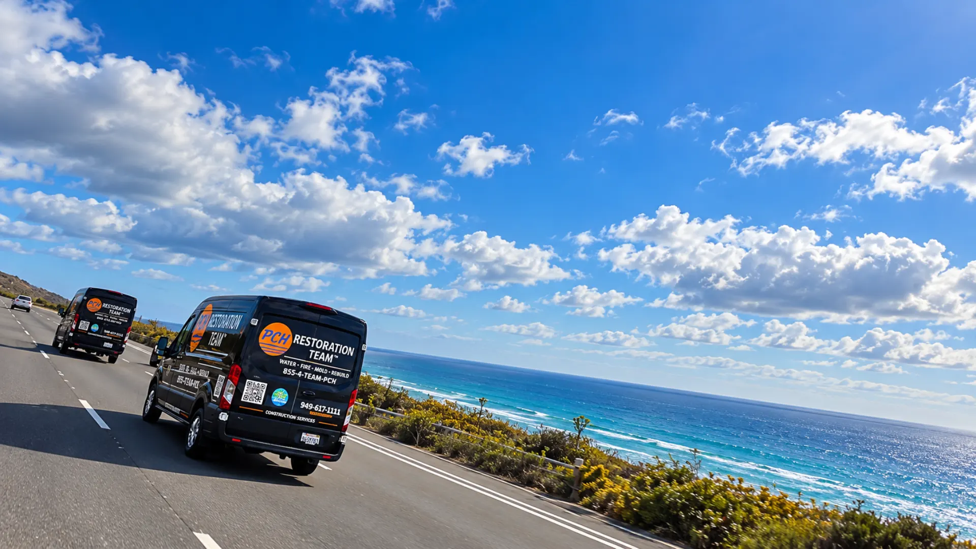Two PCH Restoration Team vans driving a coastal highway above the ocean